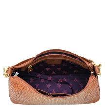 Load image into Gallery viewer, Open tan Anuschka genuine leather designer hobo bag with purple floral interior lining and chain detail shoulder strap.
