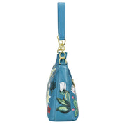 Blue floral-patterned genuine leather Anuschka wristlet bag with gold-tone hardware.