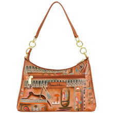 Load image into Gallery viewer, Introducing the **Zip-Top Shoulder Hobo - 707** by **Anuschka:** a sophisticated leather hobo bag with a brown exterior and gold hardware, adorned with colorful Egyptian-themed paintings. This elegant accessory features a zippered front pocket, two leather handles, and a chain detail shoulder strap for added flair. Its roomy interior ensures ample storage for all your essentials.
