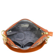 A top view of the open, sophisticated Anuschka Zip-Top Shoulder Hobo - 707 reveals a light grey, patterned interior. This spacious leather handbag includes multiple compartments and gold-colored hardware, accented by a chain detail shoulder strap.