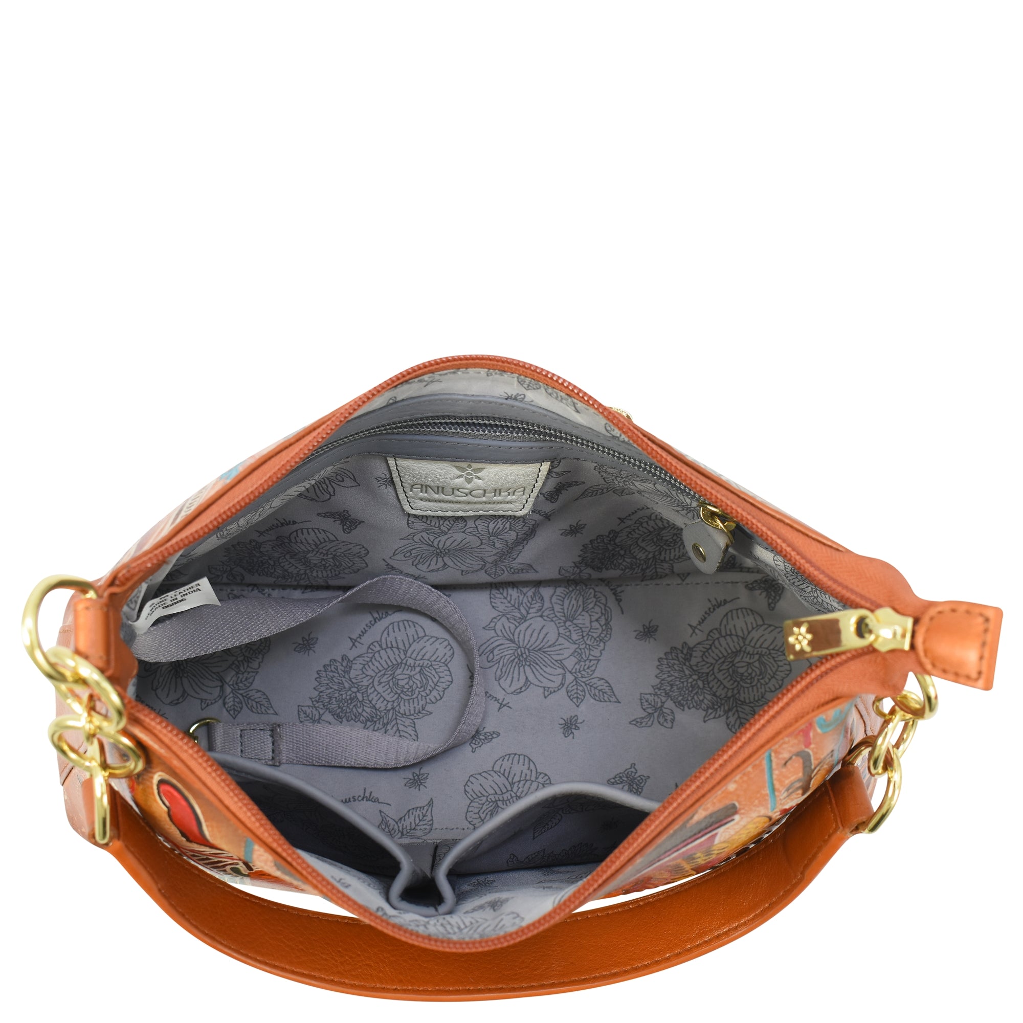 A top view of the open, sophisticated Anuschka Zip-Top Shoulder Hobo - 707 reveals a light grey, patterned interior. This spacious leather handbag includes multiple compartments and gold-colored hardware, accented by a chain detail shoulder strap.