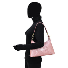 Load image into Gallery viewer, A mannequin wearing a black outfit and carrying a pink Anuschka genuine leather Hobo With Chain Strap - 707.
