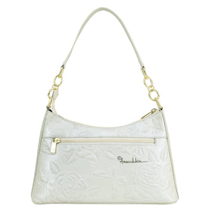 White embossed genuine leather Anuschka handbag with gold-tone hardware.