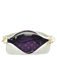 Load image into Gallery viewer, White genuine leather Anuschka Hobo With Chain Strap - 707 purse with open zipper revealing a purple floral-patterned interior and chain detail shoulder strap.
