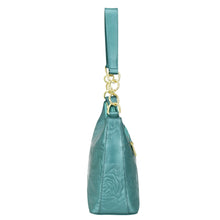Load image into Gallery viewer, An Anuschka teal genuine leather wristlet purse with floral embossing and gold-tone hardware.
