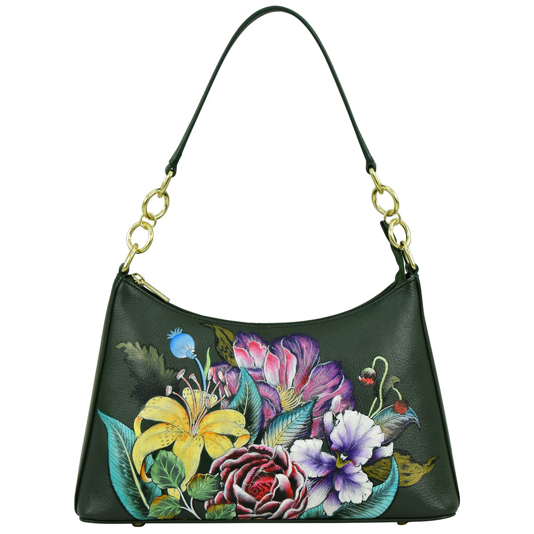 The Anuschka Zip-Top Shoulder Hobo - 707 is a dark green leather bag with a short strap and gold rings, beautifully adorned with a vibrant floral design that includes lilies, roses, and other flowers.