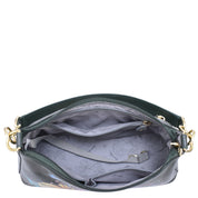 A top-down view of the open Zip-Top Shoulder Hobo - 707 by Anuschka reveals its spacious, patterned interior featuring multiple pockets and gold hardware, complemented by a chic chain detail shoulder strap. The bag is crafted from green leather.