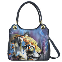 Load image into Gallery viewer, A leather Anuschka satchel with a painted leopard design on the front.

