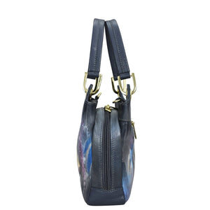 Side view of a blue floral-print leather Anuschka satchel with gold-tone hardware and shoulder straps.