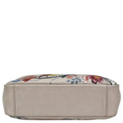 A beige leather cosmetic bag with a floral pattern on top, the Anuschka Satchel With Crossbody Strap - 708.