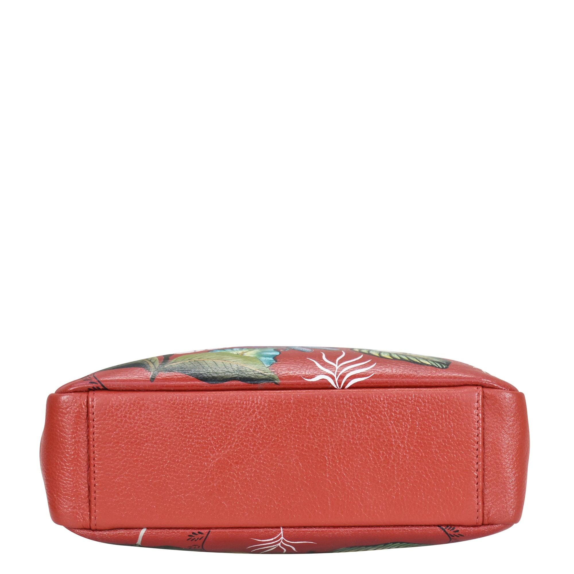 A red rectangular Satchel With Crossbody Strap - 708 by Anuschka with floral patterns, viewed from the bottom. The material appears to be genuine leather with gold hardware accents.