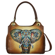 Load image into Gallery viewer, A brown leather Satchel With Crossbody Strap - 708 by Anuschka with an ornate elephant design.
