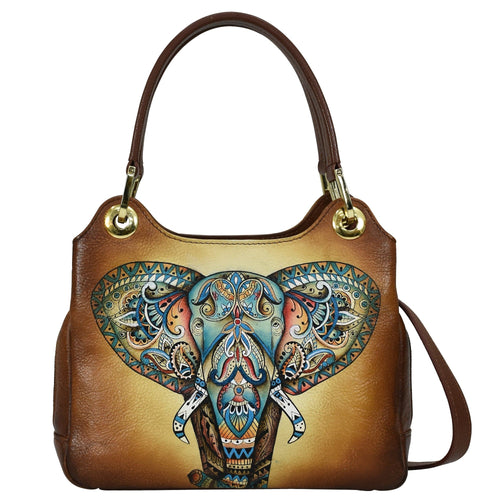 A brown leather Satchel With Crossbody Strap - 708 by Anuschka with an ornate elephant design.