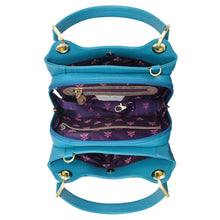 Load image into Gallery viewer, Three stacked Anuschka blue leather handbags with zippers open to reveal a purple floral interior.
