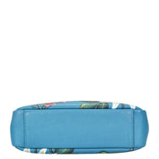 Blue and floral patterned Anuschka satchel with crossbody strap on a white background.