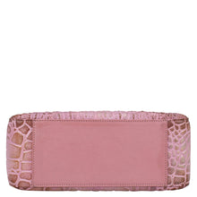 Load image into Gallery viewer, Pink Anuschka clutch with crocodile skin texture, plain central panel, and chain link detail.
