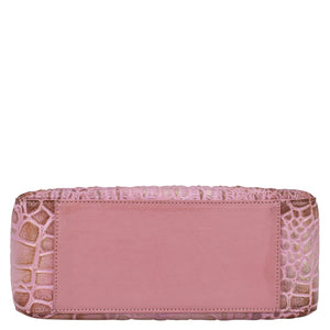 Pink Anuschka clutch with crocodile skin texture, plain central panel, and chain link detail.