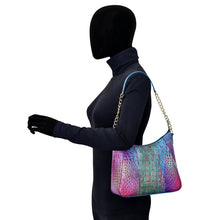 Load image into Gallery viewer, Mannequin in a black bodysuit displaying an Anuschka Zip-Top Shoulder Hobo - 709 with a chain link detail strap.

