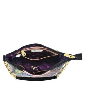 Anuschka's Zip-Top Shoulder Hobo - 709 with a gold chain link detail and a partially visible contents inside.