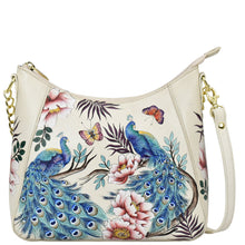 Load image into Gallery viewer, Cream-colored Anuschka Zip-Top Shoulder Hobo - 709 with floral and peacock print design and chain link detail.
