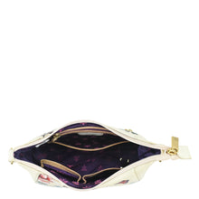 Load image into Gallery viewer, Open white Anuschka Zip-Top Shoulder Hobo - 709 with floral pattern and purple interior.
