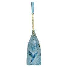 Load image into Gallery viewer, A blue floral-patterned leather Zip-Top Shoulder Hobo - 709 by Anuschka with a gold chain link detail strap and a blue ribbon handle.
