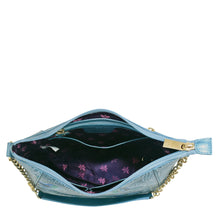 Load image into Gallery viewer, A small blue leather Zip-Top Shoulder Hobo - 709 with an open top, displaying a floral interior and a gold-colored chain link detail by Anuschka.
