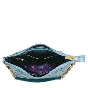 A small blue leather Zip-Top Shoulder Hobo - 709 with an open top, displaying a floral interior and a gold-colored chain link detail by Anuschka.