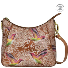 Load image into Gallery viewer, An Anuschka Zip-Top Shoulder Hobo - 709, a genuine leather purse with a floral and hummingbird print design, featuring hand-painted artwork.
