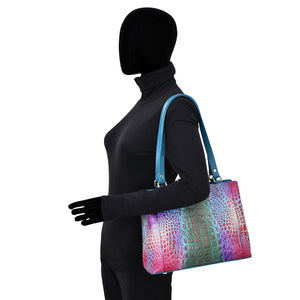 Mannequin with a Anuschka Medium Everyday Tote - 710 featuring hand-painted artwork.
