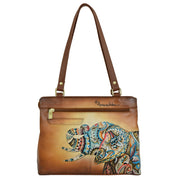 The Medium Everyday Tote - 710 by Anuschka is a brown genuine leather tote bag with dual straps, featuring a colorful elephant design, multiple pockets, and a front zipper pocket.