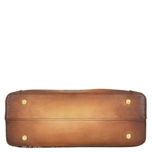 Load image into Gallery viewer, Bottom view of the Anuschka Medium Everyday Tote - 710 in brown genuine leather, featuring gold-tone stud feet. The background is white.
