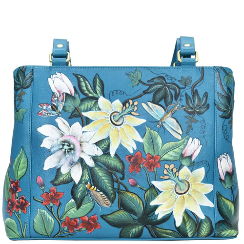 Blue floral-patterned genuine leather Anuschka handbag with shoulder strap.