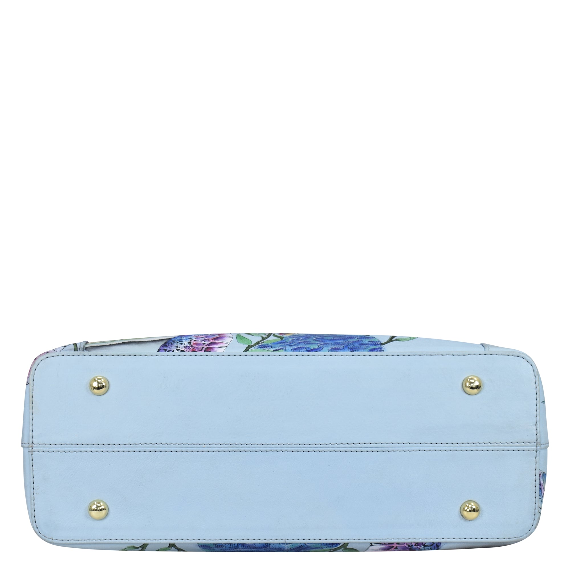 A hand-painted, floral patterned Medium Everyday Tote - 710 with a light blue base and bottom studs displayed against a white background by Anuschka.