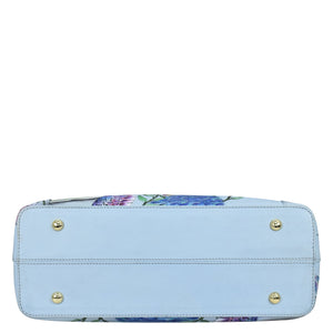 A hand-painted, floral patterned Medium Everyday Tote - 710 with a light blue base and bottom studs displayed against a white background by Anuschka.