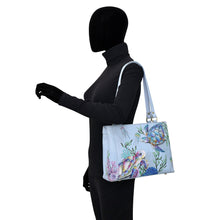Load image into Gallery viewer, Mannequin wearing a black bodysuit and showcasing a hand-painted, floral patterned Anuschka Medium Everyday Tote - 710.
