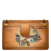 Load image into Gallery viewer, The 4 in 1 Organizer Crossbody - 711 from Anuschka is a brown genuine leather shoulder bag adorned with a colorful, intricate floral design and gold hardware. It features the brand name prominently on the front and comes with a removable crossbody strap for versatile wear.
