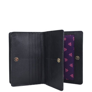 An Anuschka 4 in 1 Organizer Crossbody - 711 unfolded to reveal inner compartments with a purple floral lining.