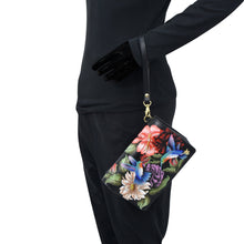 Load image into Gallery viewer, Person in black attire with an Anuschka 4 in 1 Organizer Crossbody - 711 featuring RFID blocking technology.
