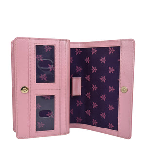 A genuine leather pink wallet with an open view, displaying multiple card slots and a floral-patterned interior equipped with RFID blocking - Anuschka's 4 in 1 Organizer Crossbody - 711.