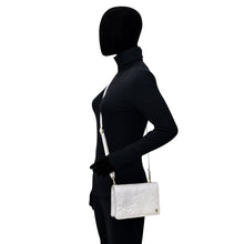 Load image into Gallery viewer, Side view of a mannequin dressed in black with an Anuschka 4 in 1 Organizer Crossbody - 711.
