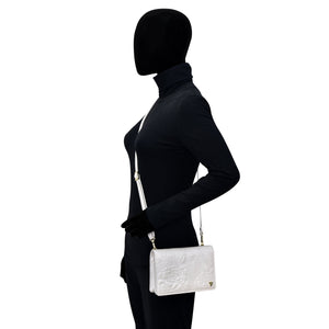 Side view of a mannequin dressed in black with an Anuschka 4 in 1 Organizer Crossbody - 711.
