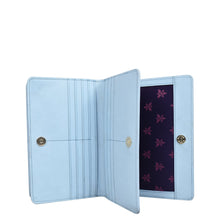 Load image into Gallery viewer, Sentence with product name and brand name: Light blue Anuschka wallet open showing interior with organized card slots and patterned lining, crafted from genuine leather.
