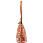 Side view of the Anuschka Expandable Shopper Tote - 712, a spacious tan-colored handbag with a patterned design, featuring a zipper closure and leather strap.