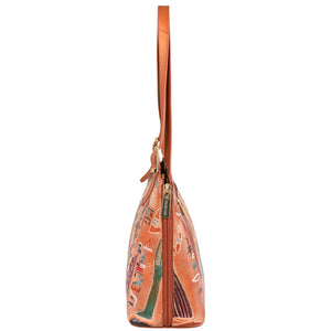 Side view of the Anuschka Expandable Shopper Tote - 712, a spacious tan-colored handbag with a patterned design, featuring a zipper closure and leather strap.