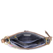 Open top view of the Anuschka Crossbody Sling Bag - 713 showcasing multiple interior compartments, including two large sections and a zippered pocket, with a floral lining and gold-tone hardware. The exterior features exquisite hand-painted artwork.