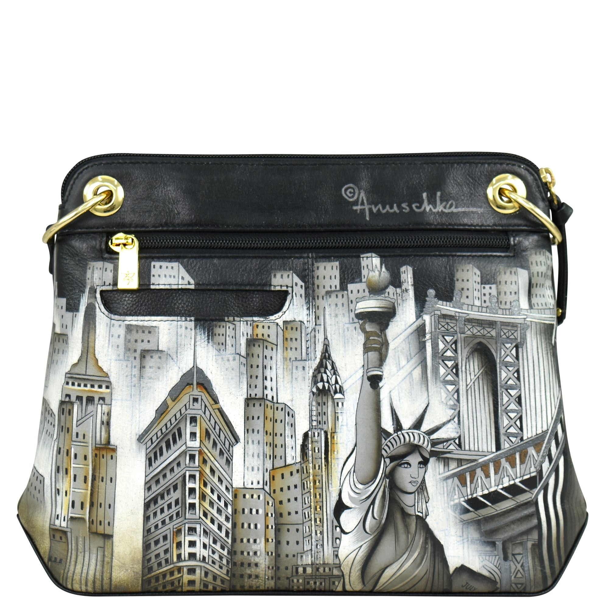 The Anuschka Crossbody Sling Bag - 713 is a black handbag made from genuine leather, adorned with hand-painted artwork depicting New York City landmarks such as the Statue of Liberty, skyscrapers, and the Brooklyn Bridge. It features gold-tone hardware, a front zipper pocket, and an adjustable crossbody strap for added convenience.