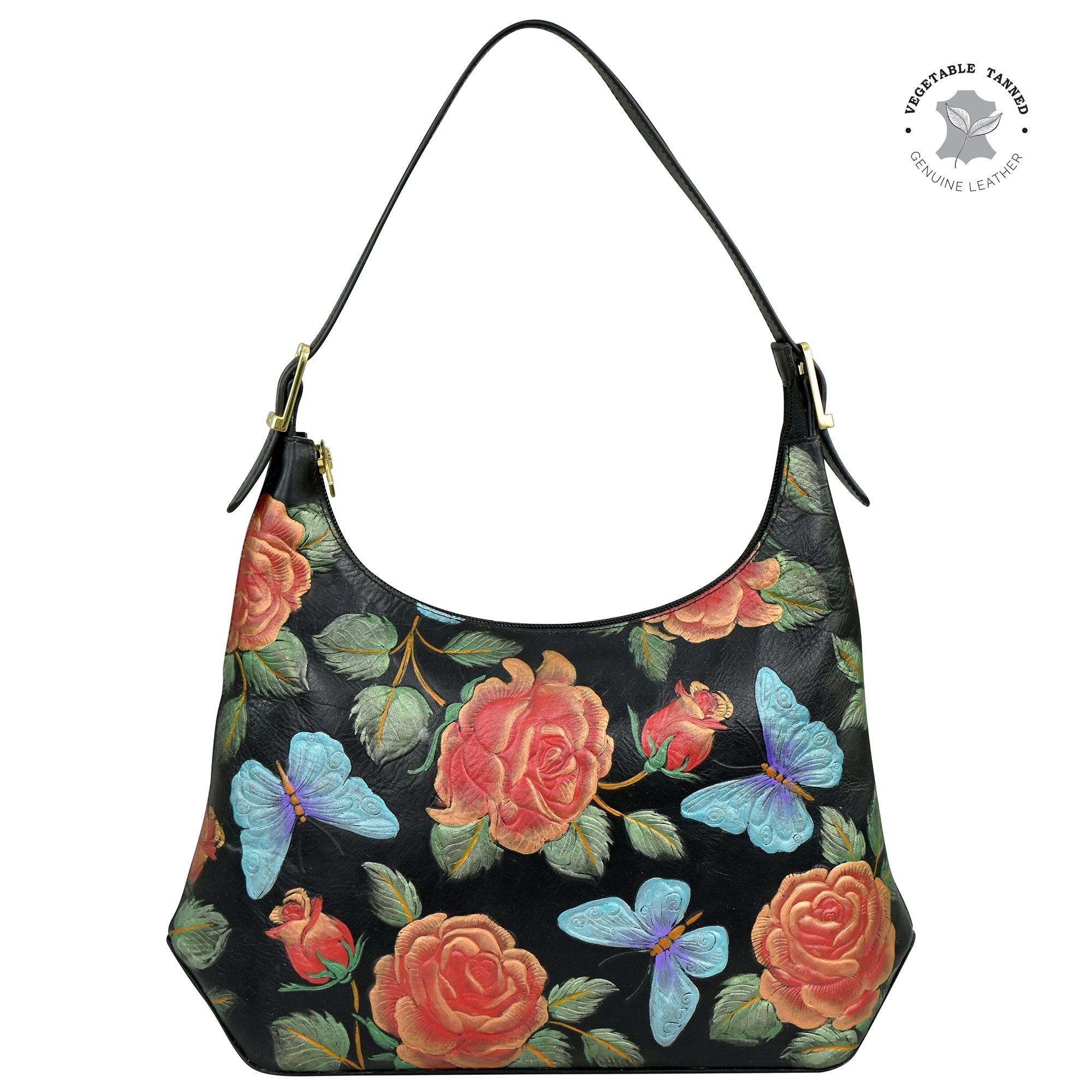 The Anuschka Slim Shoulder Hobo - 714 is a black leather handbag adorned with a vibrant floral and butterfly design. It boasts an adjustable shoulder strap and features a "Vegetable Tanned Genuine Leather" emblem in the top right corner, embodying modern style.