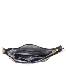 Load image into Gallery viewer, A top view of the Anuschka Slim Shoulder Hobo - 714 showcasing its interior pockets, zipper compartments, and a keyring holder. The handbag, made from genuine leather, features black edges and a floral-patterned lining.
