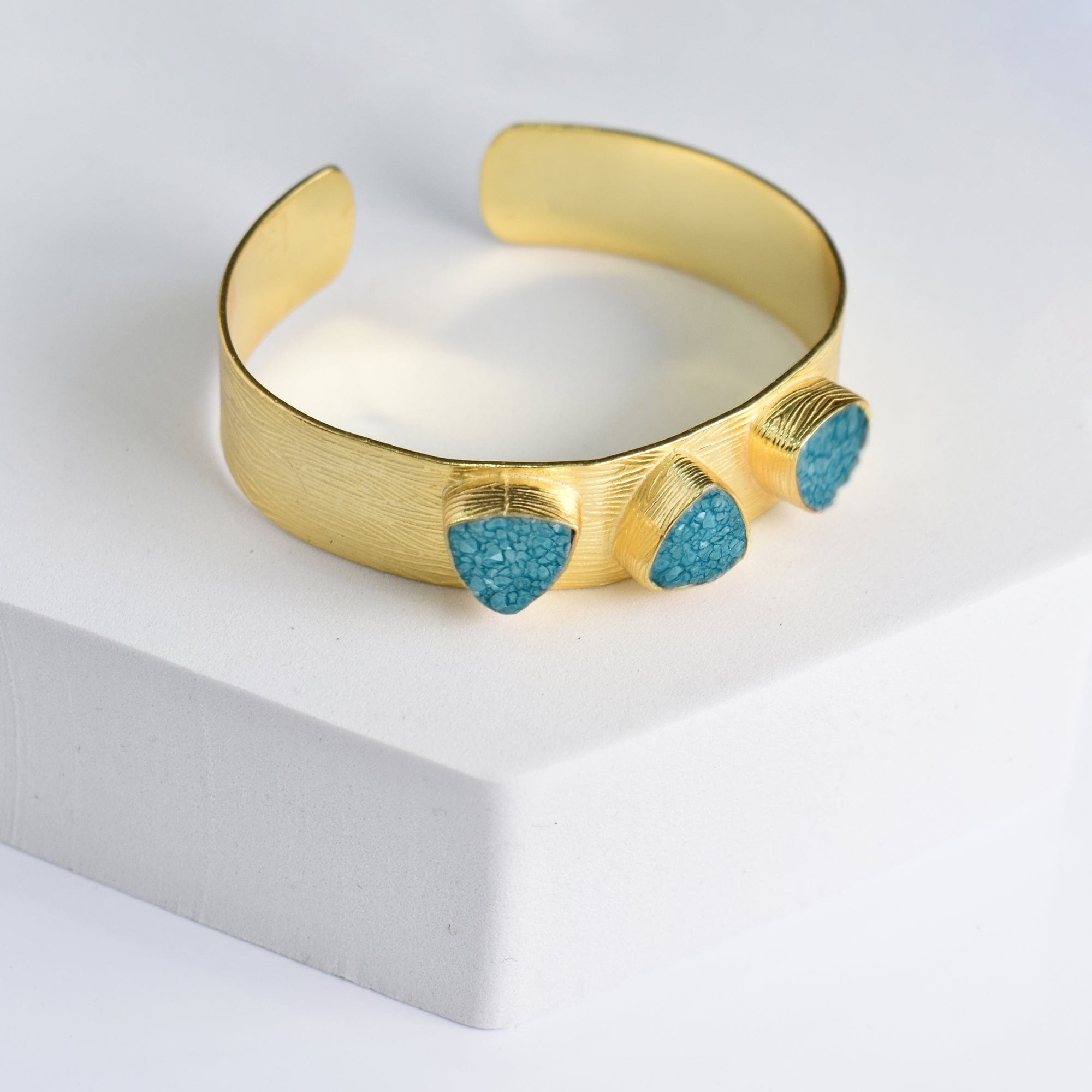 Triangle Druzy Bracelet with turquoise accents on a white display by Vanya Lara.